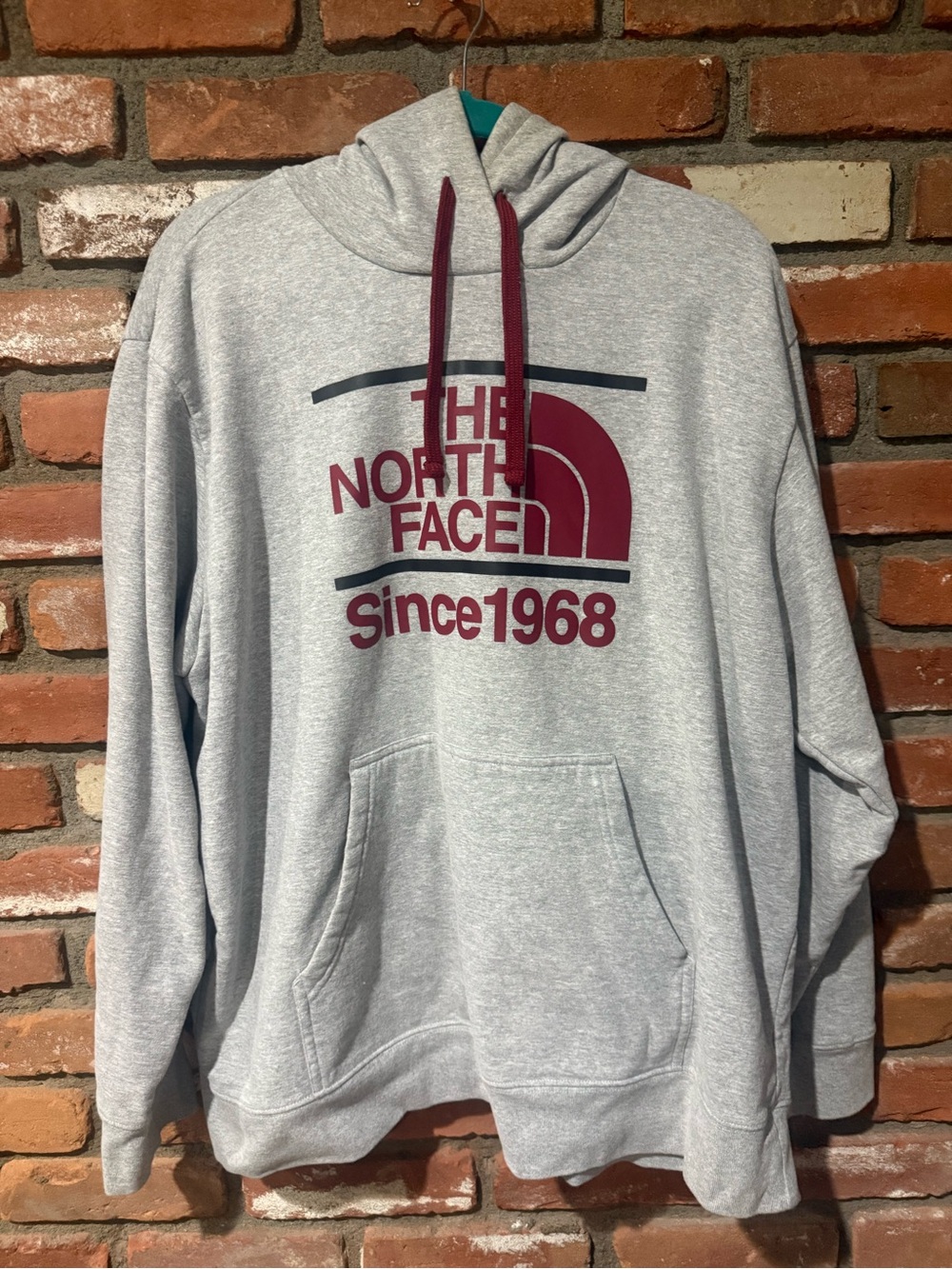 The North Face Light Gray Hoodie with Burgundy Logo and Drawstrings